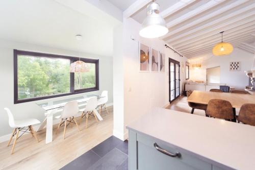 a kitchen and dining room with a table and chairs at Casa Tajo in Miraflores de la Sierra