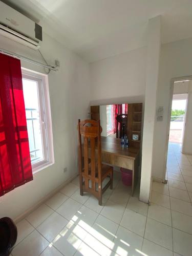 a dining room with a wooden table and a chair at The Beach House by Maasai in Mombasa