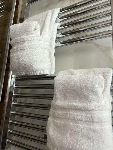 a closet with white towels on a rack at Masseria Spinale Wine Resort in Melfi