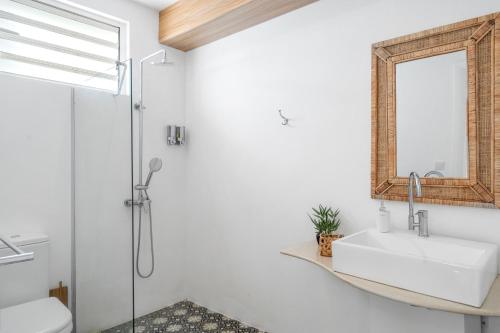 a bathroom with a sink and a mirror at Ti'Ocean Guest House - Incredible Beachfront Retreat in Grand Gaube