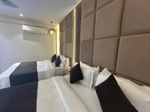 a hotel room with two beds and a wall at Royal Casa Baga in Baga