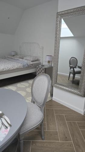 a room with a table and a mirror and a chair at Villa Marmont Karlovac Luksuzni Smještaj na Top Lokaciji s Parkingom i Self Check inom in Karlovac