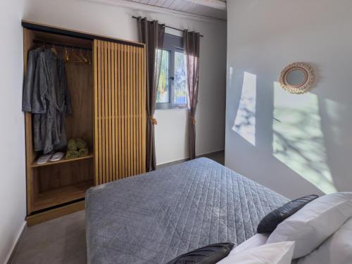 a bedroom with a bed and a closet at Antonakis Villa Rhodes Private Pool & Jacuzzi Retreat in Kremasti