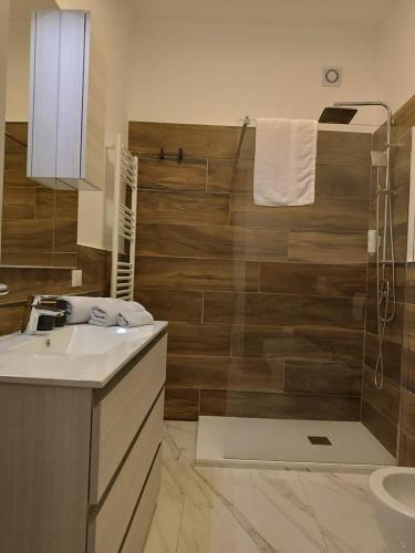 a bathroom with a sink and a shower at Umberto primo rooms in Castelbuono