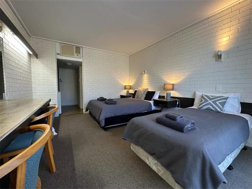 a hotel room with two beds and a couch at Sandpipers @ Millicent in Millicent