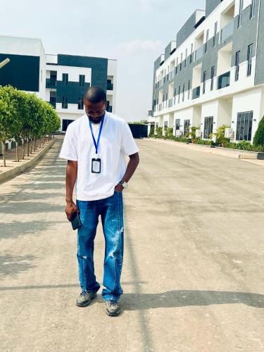 a man standing in the middle of a street at Happy Homes in Abuja
