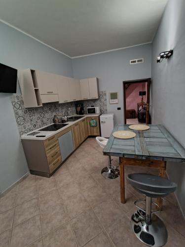 a kitchen with a table and a counter top at Residenze del Bosco - Olivo in Tuscania