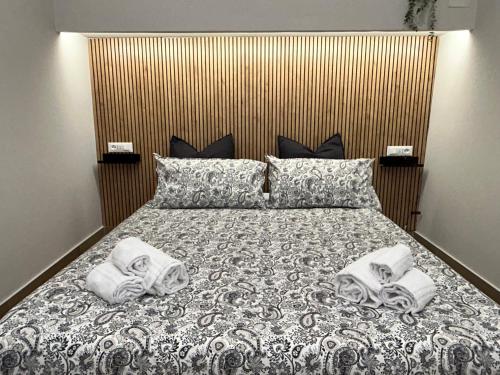 a bedroom with a bed with towels on it at La Vetere House in Catania