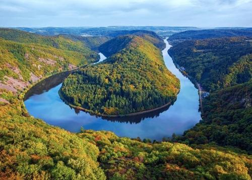an aerial view of a river in a valley at FeWo I Glücksmomente Bostalsee in Nohfelden
