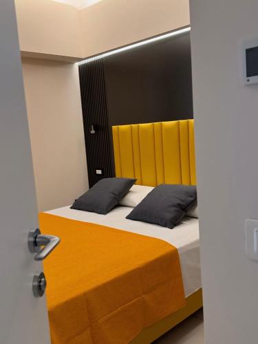 a bedroom with a bed with two pillows at Luxury Home Station in Tropea