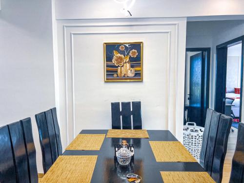 a dining room with a table and chairs at Stone Age Nairobi --- Rooftop Pool & Lounge, Gym, Games room, Office Space in Nairobi