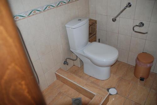 a bathroom with a toilet in a tiled room at Olympos House in Litochoro