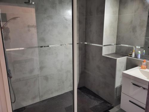 une douche avec une porte vitrée dans une salle de bain dans l'établissement Charmant T2 vue mer, à Bastia