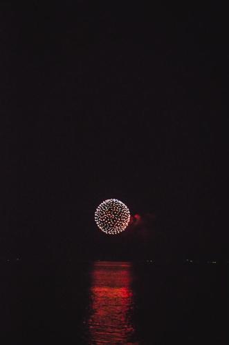 a firework display in the sky over the water at night at 【佐渡/一棟貸切】オーシャンビュー古民家SeaSideStory椿 離れ in Sado