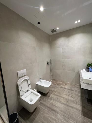 a bathroom with a toilet and a sink at Sea View Luxury Apartment in Vlorë