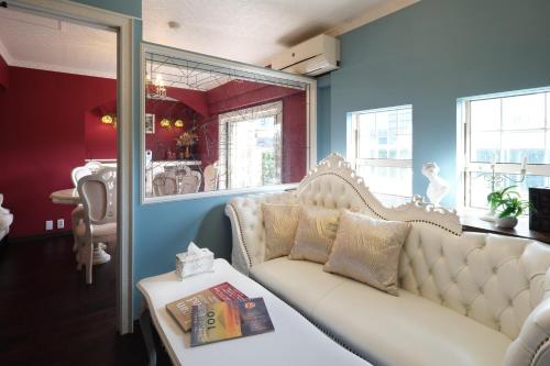 a living room with a couch and a table at Spacious 80sqm Apt near Shibuya Crossing, 8 min walk to Shibuya Station in Tokyo