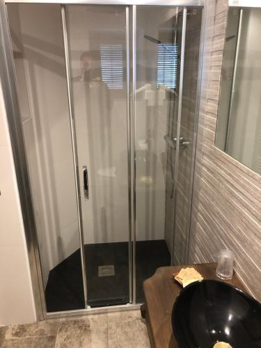 a bathroom with a shower with a black sink at Casa FOR HABITACIONES in Labuerda