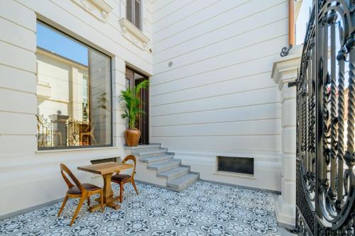 a patio with a table and chairs on a house at Arctic Boutique Hotel in Korçë