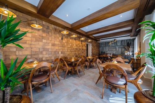 a restaurant with wooden tables and chairs at Arctic Boutique Hotel in Korçë