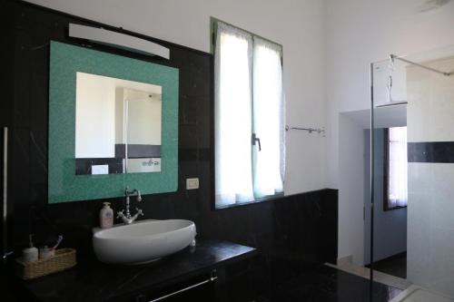 a bathroom with a white sink and a mirror at Villa Ines in Pove del Grappa