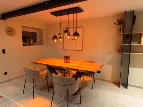 a dining room with a wooden table and chairs at J ean Reve in Rendeux