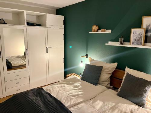 a bedroom with a bed and a white cabinet at Bergnest Bad Bayersoien in Bad Bayersoien
