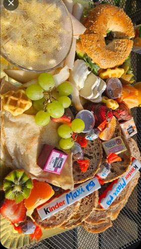 a plate of food with grapes and other foods at Le Palais Secret 66 Loveroom in Saint-Féliu-dʼAvall