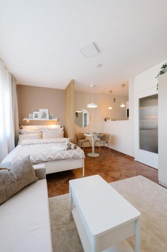 a bedroom with a bed and a living room at Air & Fair Apartment in Düsseldorf