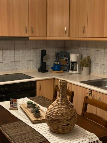 a kitchen with a table with a vase on it at Seaesta House in Keramotí