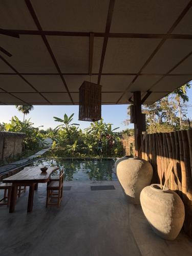 a patio with a table and chairs and a pool at SatyaVilla6 in Havelock Island