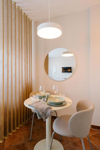 a dining room with a table and chairs and a mirror at Air & Fair Apartment in Düsseldorf