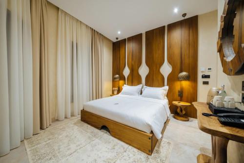 a bedroom with a bed and a desk at Arctic Boutique Hotel in Korçë