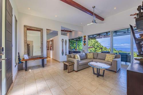 a living room with a couch and a table at Ocean View Villa With Pool and Spectacular Sunsets in Ballena