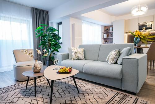 a living room with a couch and a table at Novos Luxury Suites in Bucharest