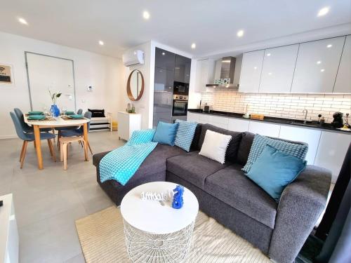 a living room with a couch and a table at Modern Apartment in Portimão in Portimão