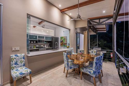 a dining room with a wooden table and chairs at Ocean View Villa With Pool and Spectacular Sunsets in Ballena