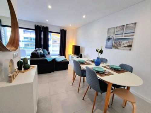 a kitchen and living room with a table and chairs at Modern Apartment in Portimão in Portimão