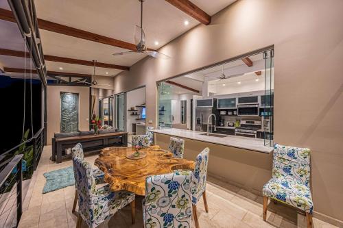 a dining room with a wooden table and chairs at Ocean View Villa With Pool and Spectacular Sunsets in Ballena