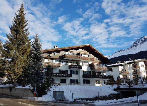 a large building with snow in front of a mountain at Helvetia 2005 Sr 2-ZW 2 Stock in Lenzerheide