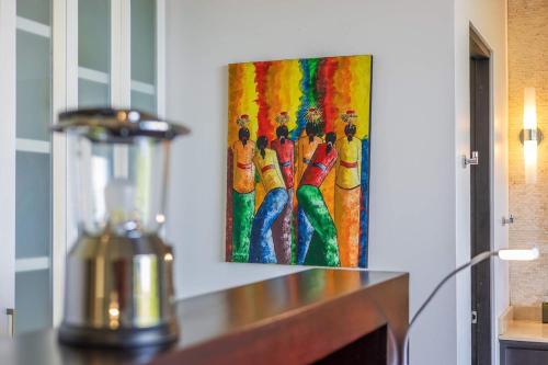 a painting of a group of people on a wall at Ocean View Villa With Pool and Spectacular Sunsets in Ballena