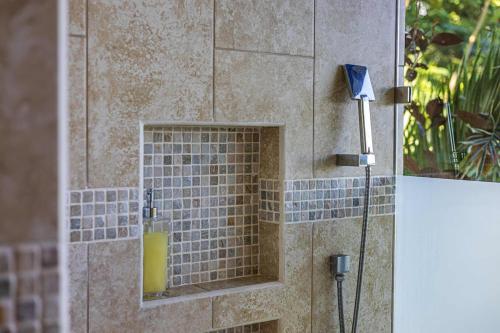 a shower with a blue tile niche in a bathroom at Ocean View Villa With Pool and Spectacular Sunsets in Ballena