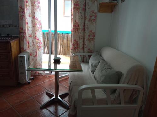 a living room with a couch and a glass table at La Casita 18 in Ardales