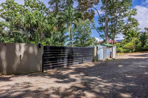 a fence in front of a road with trees at Ocean View Villa With Pool and Spectacular Sunsets in Ballena