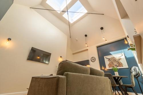 a living room with a couch and a tv at Grayling Cottage in Ambleside