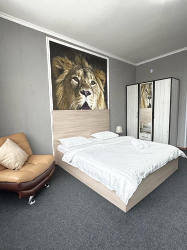 a bedroom with a bed with a picture of a lion at Turan in Karagandy