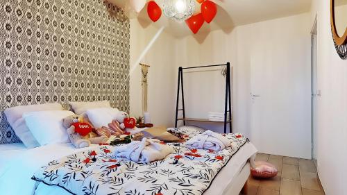 a bedroom with a bed with a woman laying on it at Suite climatisée, 2 personnes in Montry