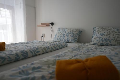two beds sitting next to each other in a bedroom at Center Hostel and Guest House in Budapest