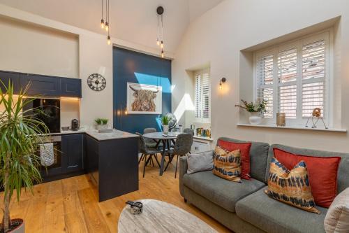 a living room with a couch and a table at Grayling Cottage in Ambleside