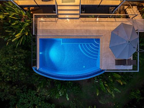 an overhead view of a swimming pool with an umbrella at Ocean View Villa With Pool and Spectacular Sunsets in Ballena