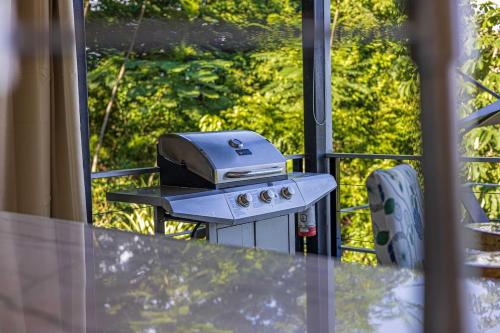a grill sitting on a table on a balcony at Ocean View Villa With Pool and Spectacular Sunsets in Ballena